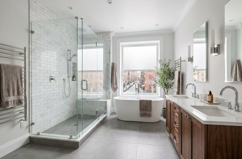 Modern remodeled bathroom in a New York home with glass shower, soaking tub, and double vanity